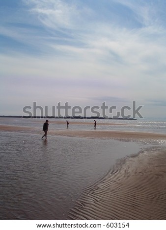 three women walking in the tide pools