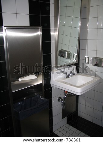 handicap bathroom with slanted mirror and raised sink for wheelchair access