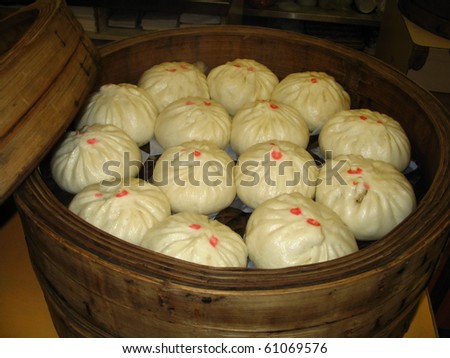 freshly steamed Chinese buns in old wooden steamer