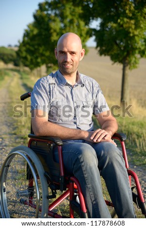 smiling man in wheelchair
