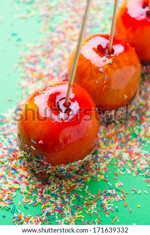 three candied apples with sugar sprinkles