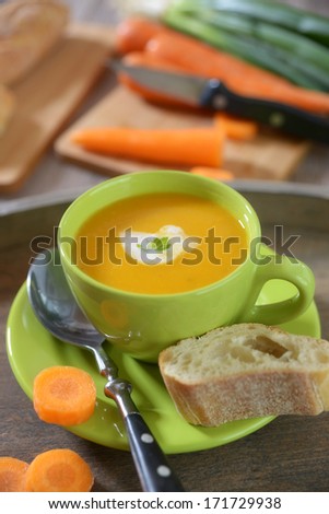 bowl with carrot soup and bread