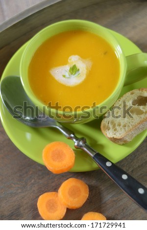 bowl with carrot soup and bread