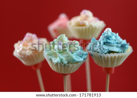 sweet cake pops with frosting and sugar sprinkles