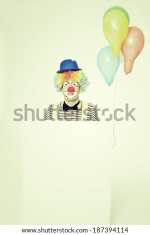 happy clown with an advertising board