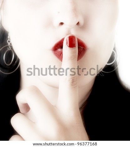 woman with finger on lips