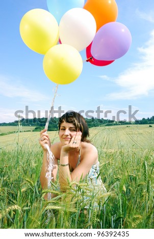 young happy woman with a bunch of balloons