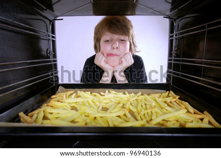 boy at the oven baking french fries
