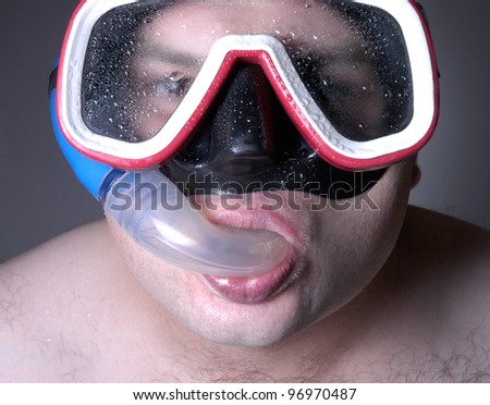 man with diving mask and snorkel ready to swim