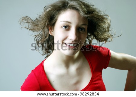 smiling young woman with windy hair