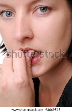 portrait of a young woman biting nails