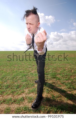 man in business clothing is ready to fight outdoors