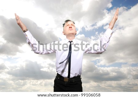 portrait of a strange man in business clothing against cloudy sky