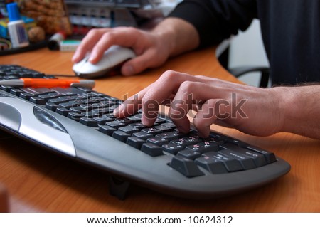 male hand typing on black keyboard