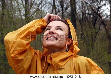 girl in orange raincoat admiring the rainy weather