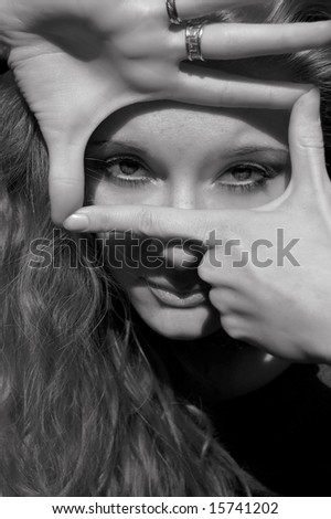 Beautiful girl making signs with hands, black and white image