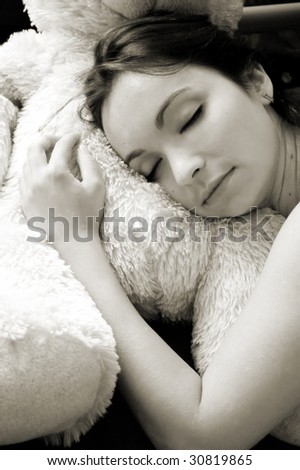 Beautiful girl sleeping on soft pillow in sepia