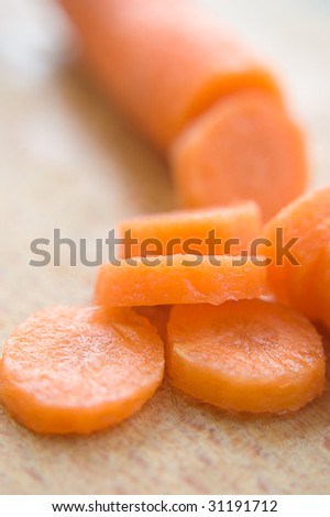 Chopped carrot in circles on wood board