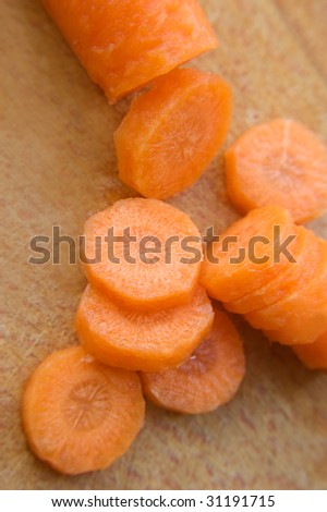 Chopped carrot in circle on wooden board