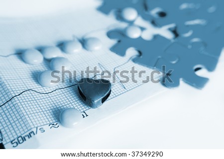 ECG diagram and pills with symbolic heart, blue toned