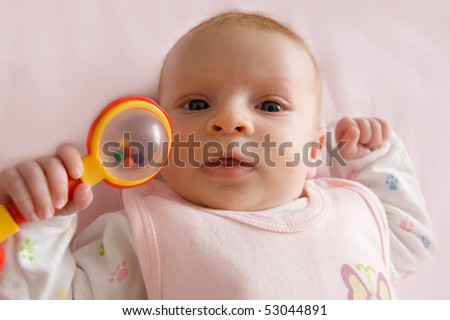 Month  Baby Pictures on Three Months Old Baby Girl Holding Rattle Stock Photo 53044891