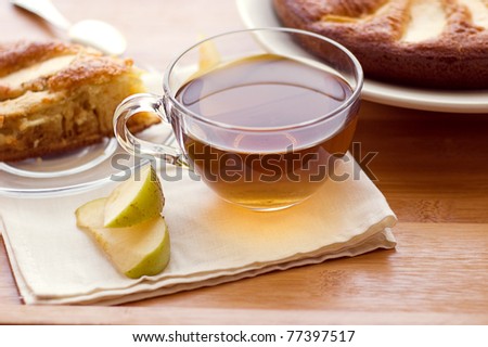 Tea cup with apple pie on table