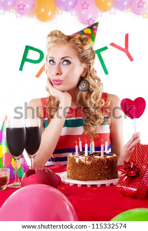 Surprised pinup girl sitting at party table with balloons over white