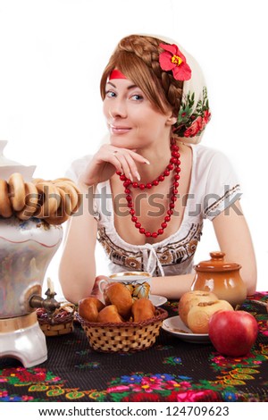 Hospitable russian woman welcomes to drinking tea with samovar over white