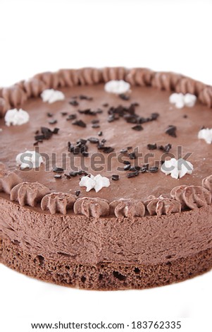 Part of round chocolate cake isolated on white background