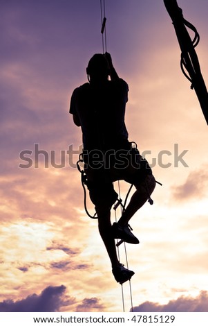 Silhouette of a Man Climbing to the Top