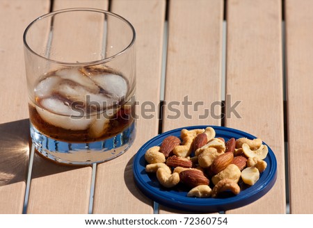 Cocktail and mixed nuts on the outside bar