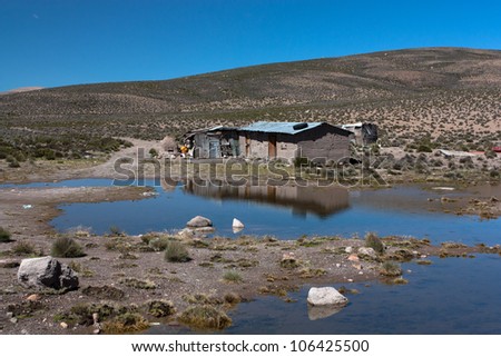 Deserted house reflecting in a lake, at the border between Chile  and Bolivia in Lauca National Park