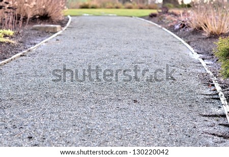 Long gravel path in the park on raining day