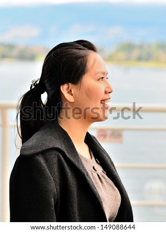 Beautiful Asian young woman outdoor portrait with side profile shot
