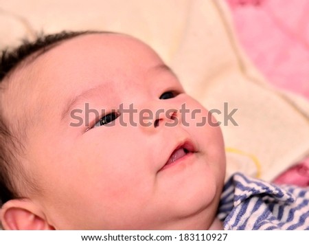 Baby with innocent look face closeup
