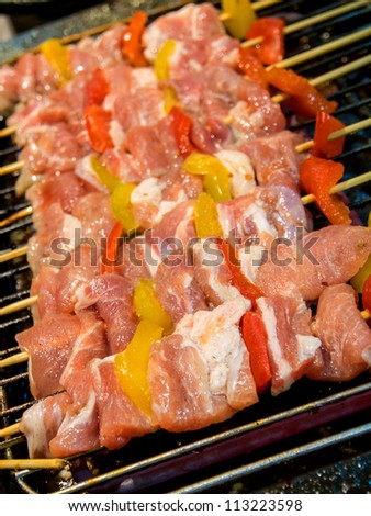 Barbecue on sticks - meat and vegetables frying