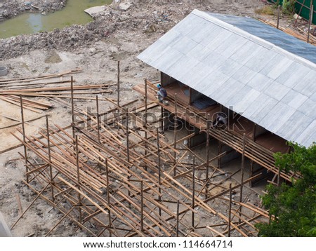 house construction work with worker nailing the wooden path
