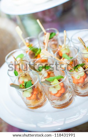 spicy pork in small shot glass with sticks as appetizer for the wedding party or business meeting