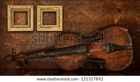 Golden frames with background of old broken violin layered with old grunge paper