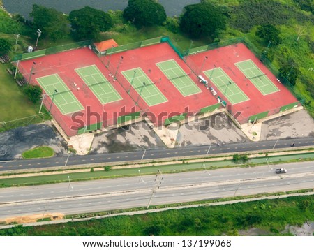 Bird eye view from private air craft, view of Bangkok crowded city view of tennis court next to the main road