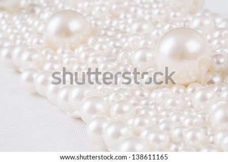 Pile of pearl sewed together with two big ones