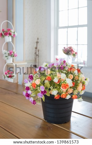 colorful flowers on the table with windowsill at the back