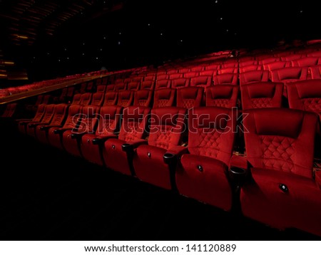 Rows Of Red Movie Theater Seats In Dark Surrounding