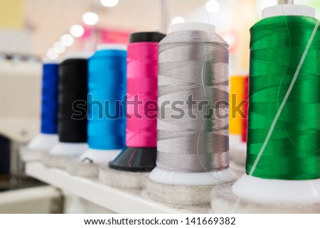 Colorful Thread roll on sewing machine in factory