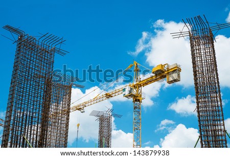 crane operating among metal foundation poles