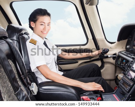 Young Asian pilot student in her uniform flying light craft plane in the sky