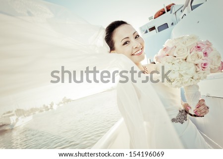 Pastel tone of young asian bride having her wedding party on small cruise