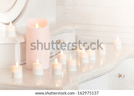 vintage picture of candles set in front of the make up table with mirror