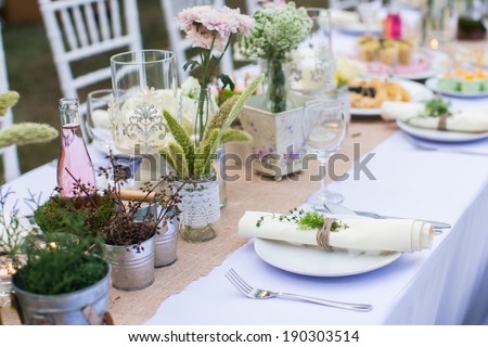 Outdoor catering dinner at the wedding with homemade garnishes decoration