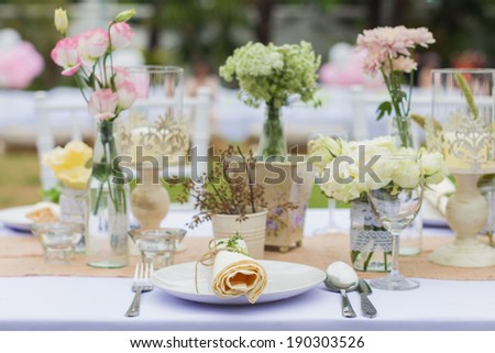 Outdoor catering dinner at the wedding with homemade garnishes decoration